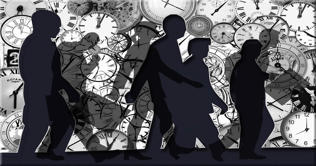 Silhouette of people in front of a thousand clocks